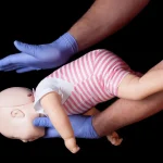Doctor showing first aid for choking infant