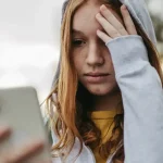 teen on phone cyberbully (1)